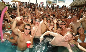 A group of spring breakers parties and considers how to make standing in a pool sound infinitely more fun when they get home.